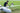 Person demonstrating simple installation of Skyeye Carbon fiber 6000mm UAV Fixed Wing Drone on grass.